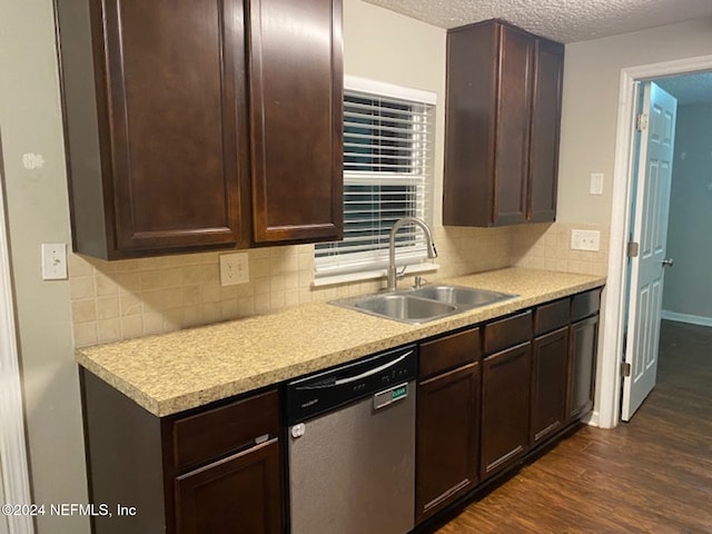 kitchen with dark hardwood / wood-style floors, sink, stainless steel dishwasher, a textured ceiling, and tasteful backsplash