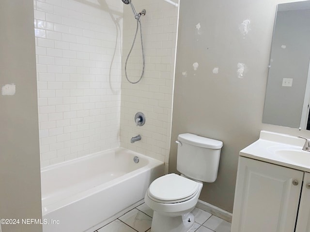 full bathroom featuring tiled shower / bath, vanity, and toilet