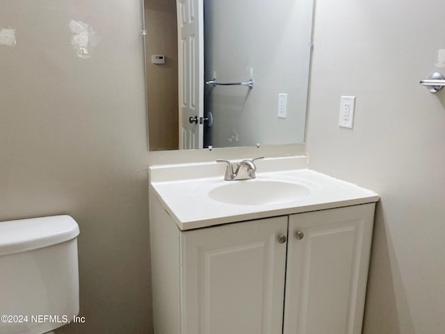 bathroom featuring vanity and toilet