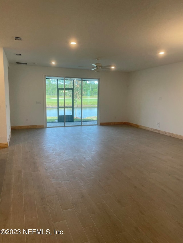 unfurnished room with hardwood / wood-style flooring and ceiling fan