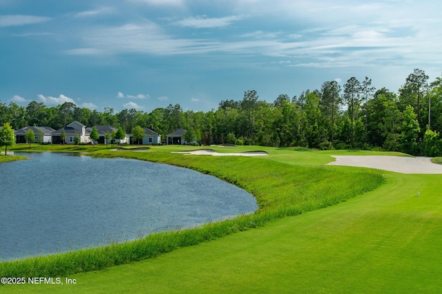 surrounding community featuring a water view and a lawn