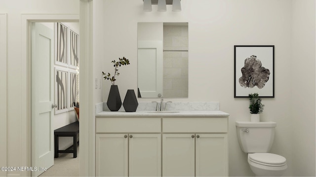 bathroom featuring toilet and vanity