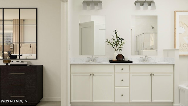 bathroom featuring a shower with door and vanity