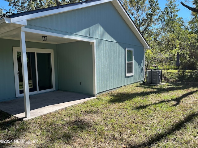 rear view of property featuring a patio area, a lawn, and central AC unit