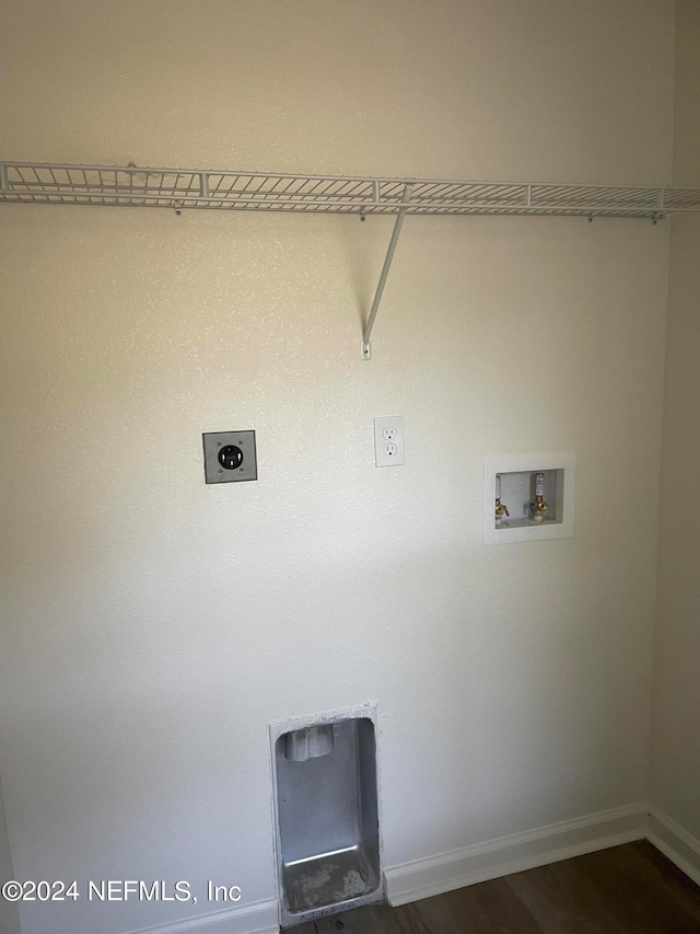 clothes washing area featuring hookup for an electric dryer, washer hookup, and dark hardwood / wood-style flooring