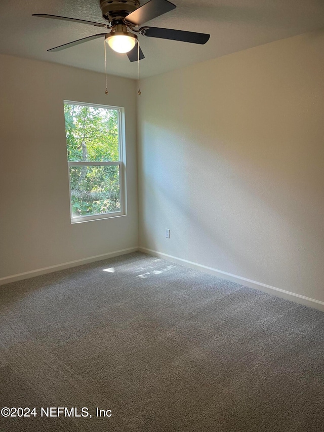 empty room with carpet floors and ceiling fan