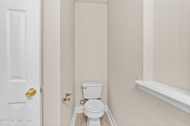 bathroom featuring toilet and hardwood / wood-style floors