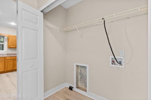 washroom with light hardwood / wood-style flooring and hookup for a washing machine