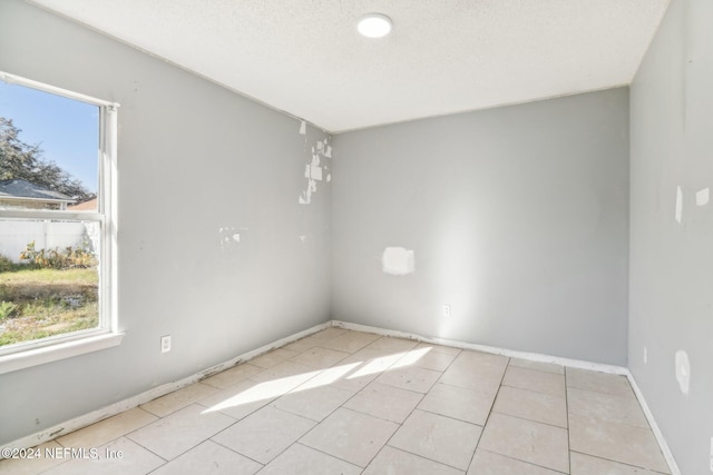 spare room with a textured ceiling