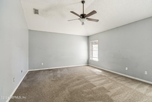 empty room with ceiling fan, carpet, and a textured ceiling