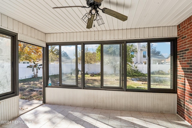 unfurnished sunroom featuring plenty of natural light and ceiling fan