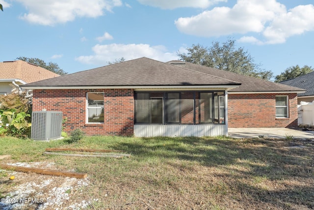 back of property with a lawn, a patio, and central air condition unit