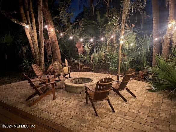 patio at night with an outdoor fire pit