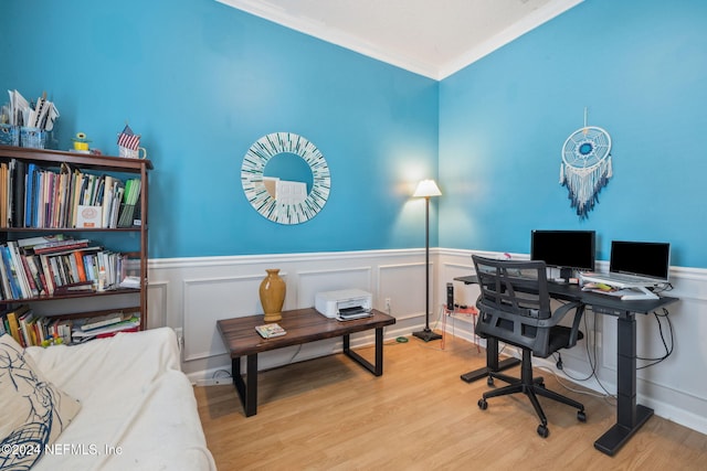 office with light wood-type flooring and ornamental molding