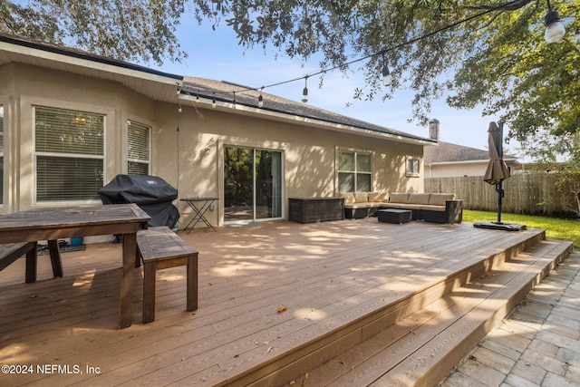 deck featuring outdoor lounge area and area for grilling