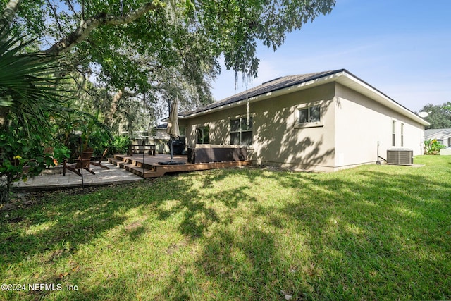 back of house featuring central air condition unit, a yard, a patio, and a deck