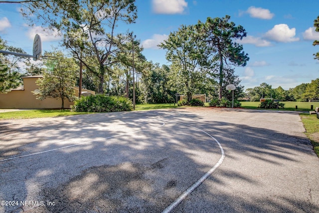 view of sport court with a yard