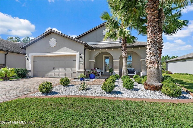 view of front of house featuring a front yard and a garage