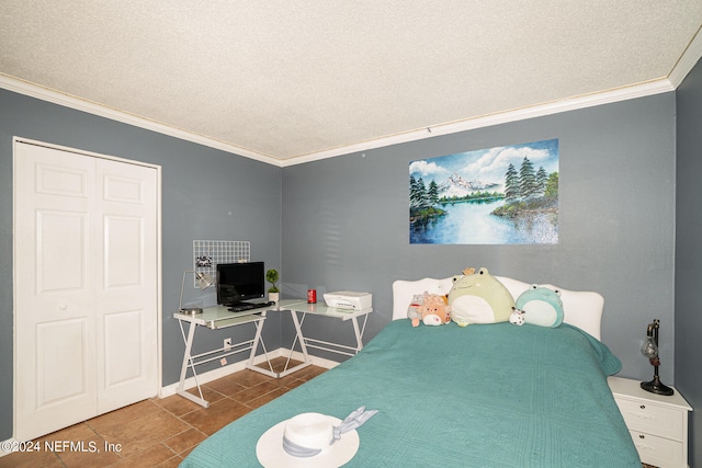 bedroom with ornamental molding, a textured ceiling, a closet, and tile patterned flooring