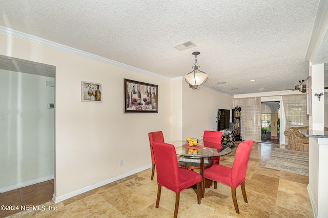 dining room with ornamental molding and a textured ceiling