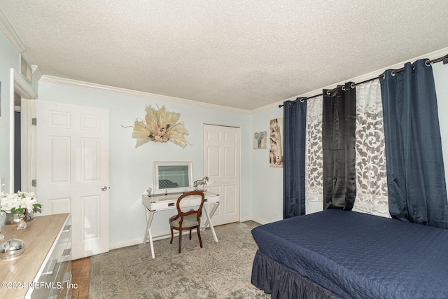 bedroom featuring ornamental molding, a textured ceiling, and hardwood / wood-style floors