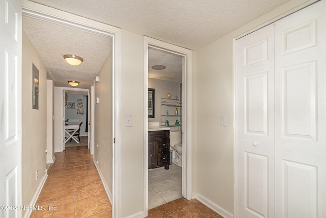 hallway featuring a textured ceiling