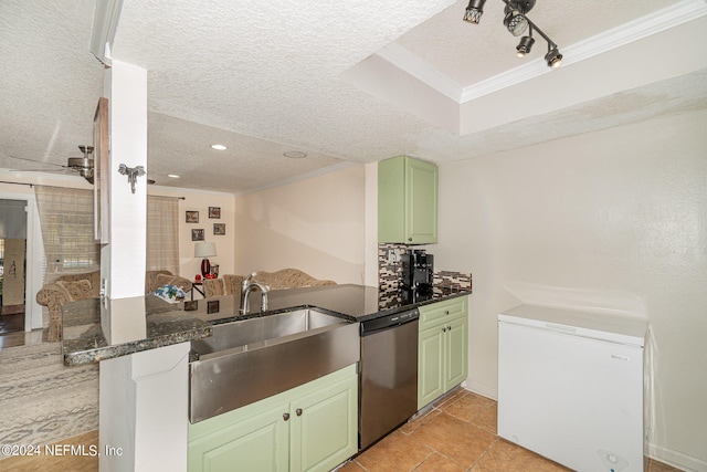 kitchen featuring kitchen peninsula, green cabinets, sink, stainless steel dishwasher, and a textured ceiling