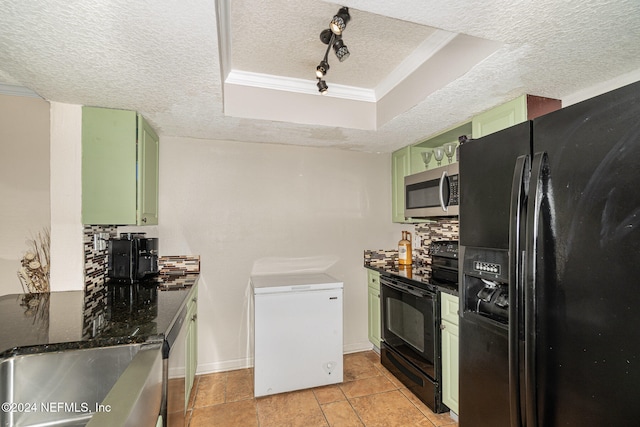 kitchen featuring a textured ceiling, green cabinets, black appliances, and backsplash