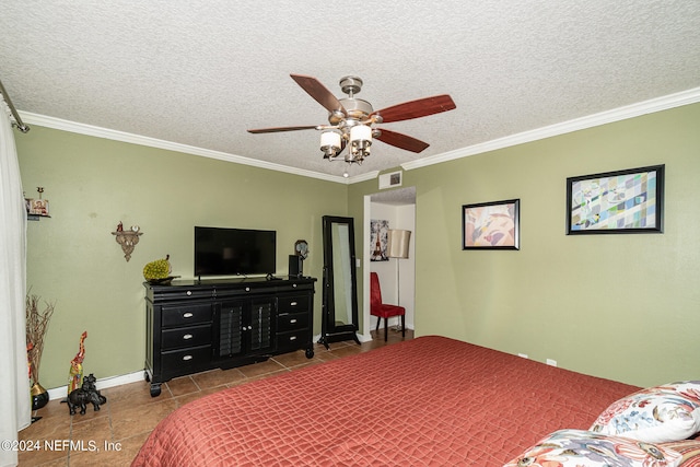 tiled bedroom featuring ornamental molding, a textured ceiling, and ceiling fan