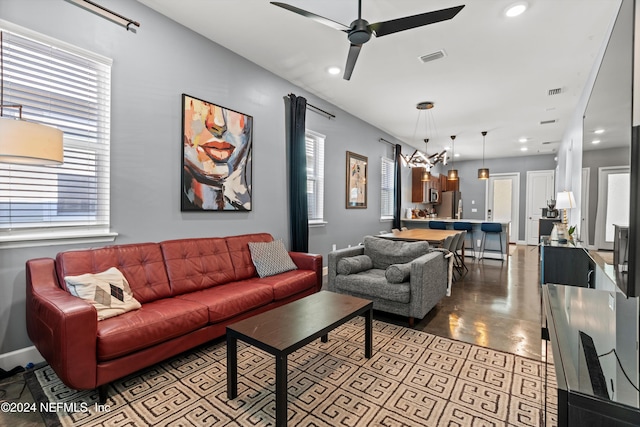 living room featuring a wealth of natural light and ceiling fan