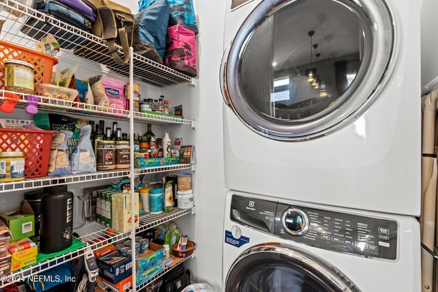 laundry area featuring stacked washer / drying machine