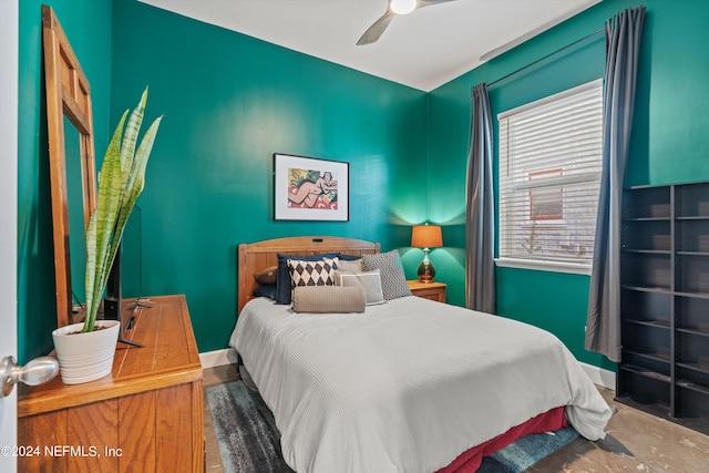 bedroom with ceiling fan and wood-type flooring