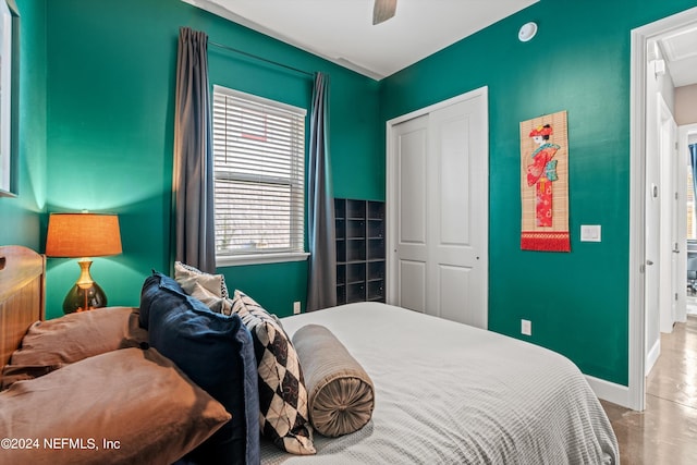 bedroom featuring a closet, concrete floors, and ceiling fan