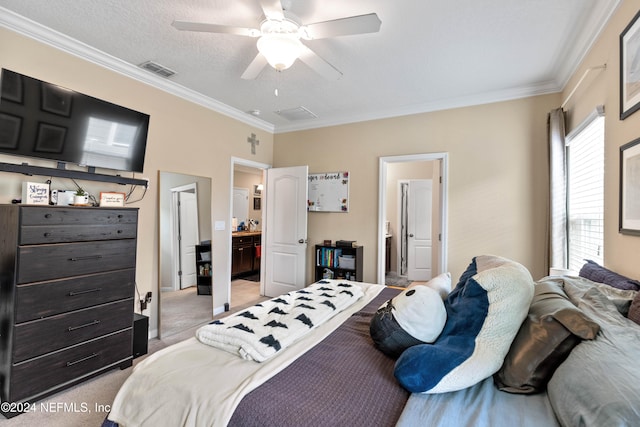 carpeted bedroom featuring ensuite bathroom, crown molding, a textured ceiling, and ceiling fan