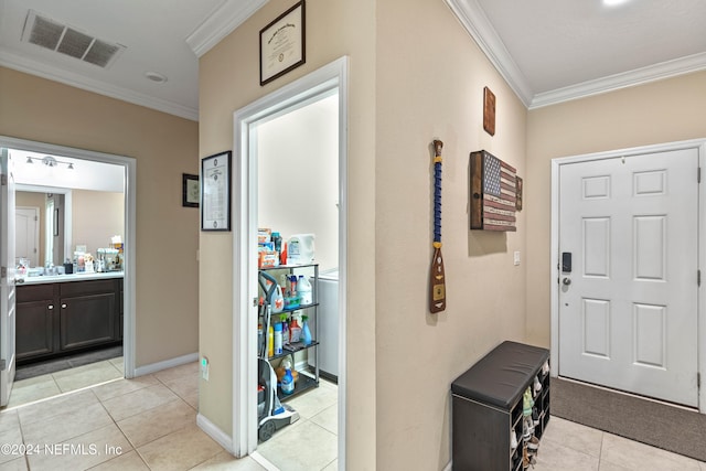 corridor featuring ornamental molding, sink, and light tile patterned floors