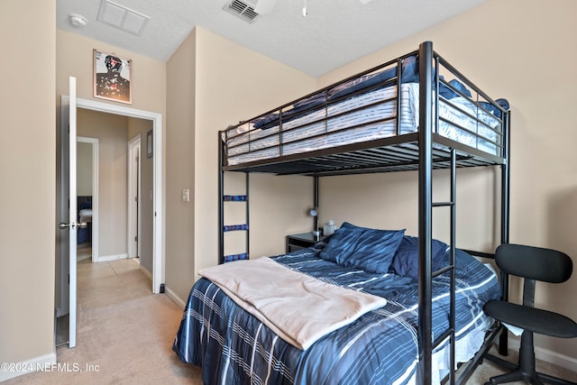 bedroom featuring carpet and a textured ceiling