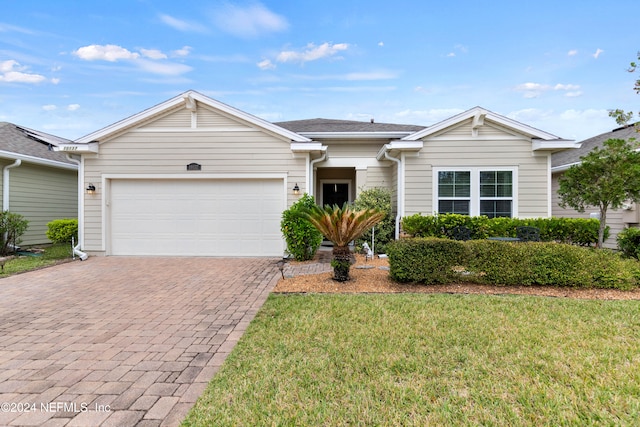 single story home with a front yard and a garage