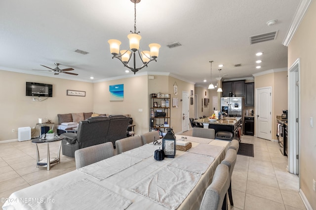 dining space with ornamental molding, light tile patterned flooring, and ceiling fan with notable chandelier