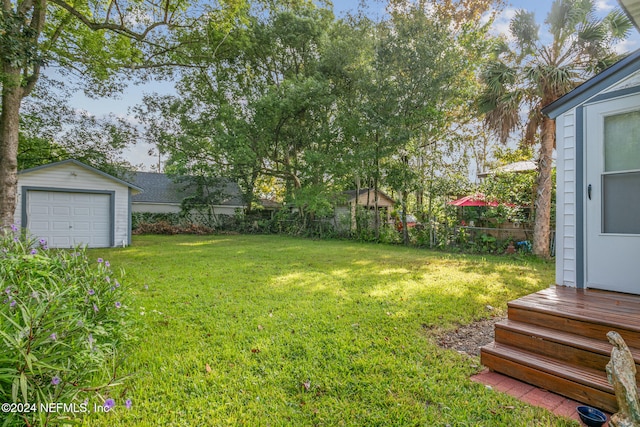 view of yard with an outdoor structure and a garage