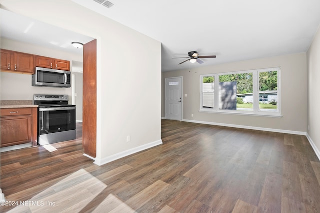 unfurnished living room featuring ceiling fan and dark hardwood / wood-style flooring