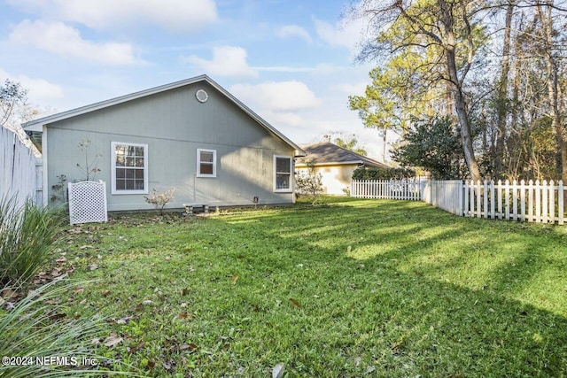 back of property featuring a yard