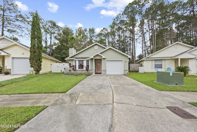 single story home featuring a front yard and a garage