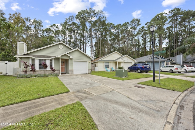 ranch-style house featuring a garage and a front lawn