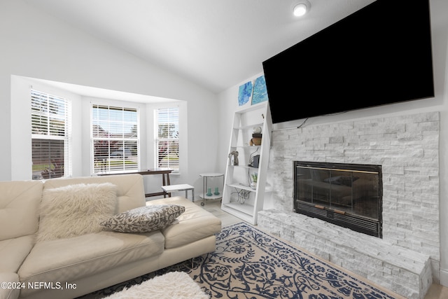 living room featuring a fireplace and high vaulted ceiling