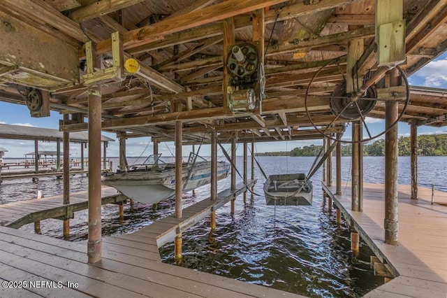 view of dock featuring boat lift and a water view