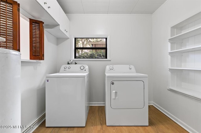 washroom featuring laundry area, washer and clothes dryer, and light wood-style flooring