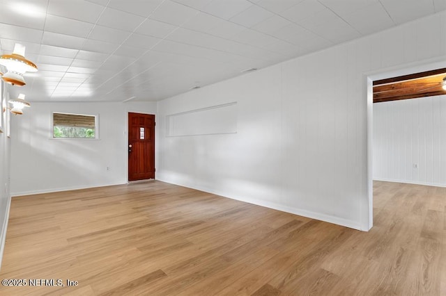 interior space with baseboards and light wood-style flooring