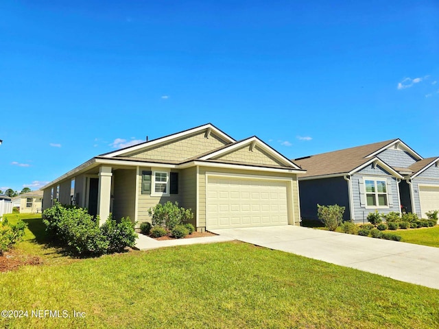 view of front of house featuring a garage and a front lawn