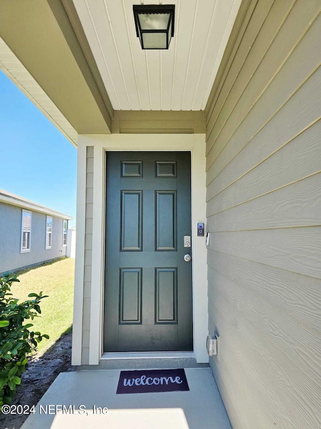 entrance to property with a yard