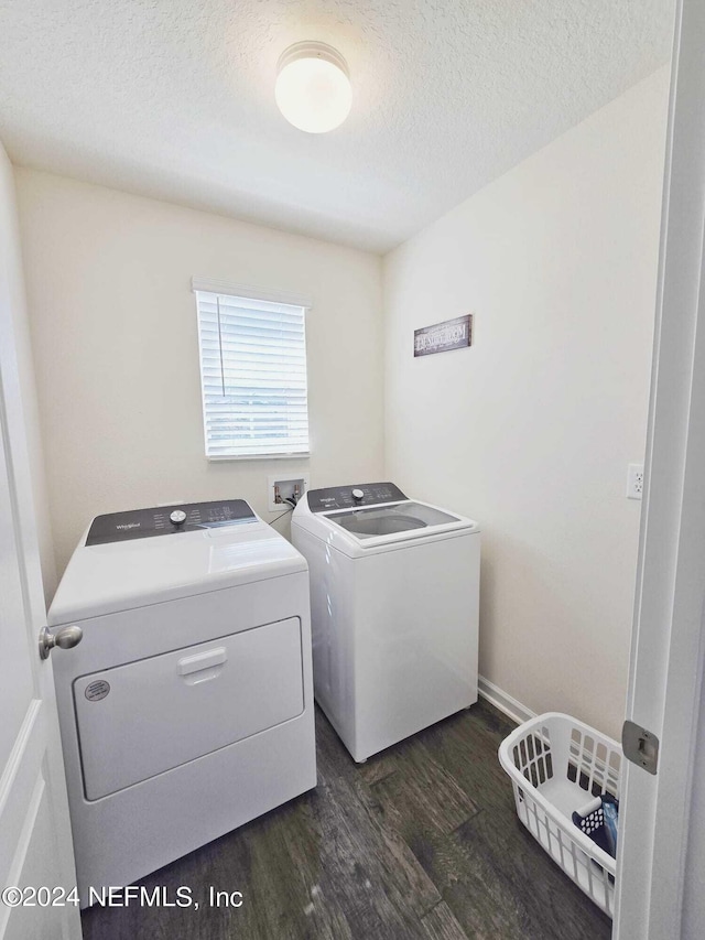 clothes washing area featuring washer and dryer, a textured ceiling, and dark hardwood / wood-style flooring